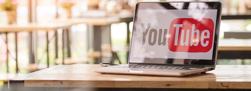 a laptop on a table streaming a video