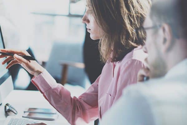 woman in front of a screen looking for a hosting provider